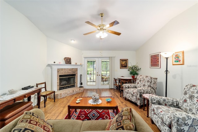 1602 NW 117th Ter, Gainesville, FL 32606 - living room featuring vaulted ceiling, a ceiling fan, wood finished floors, french doors, and a fireplace