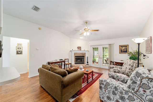 1602 NW 117th Ter, Gainesville, FL 32606 - living room featuring ceiling fan, a fireplace, light wood-style floors, and french doors