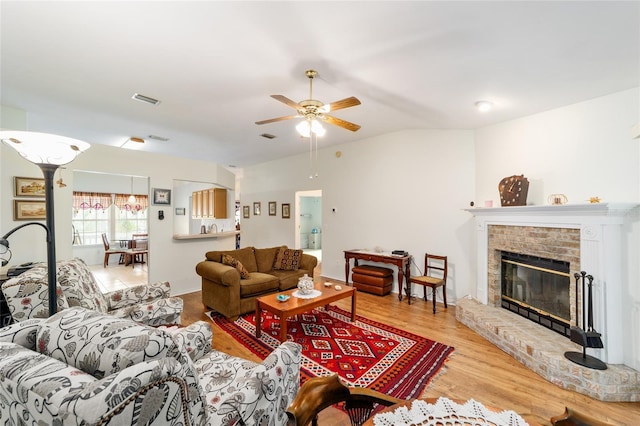 1602 NW 117th Ter, Gainesville, FL 32606 - living area with vaulted ceiling, ceiling fan, wood finished floors, and a brick fireplace