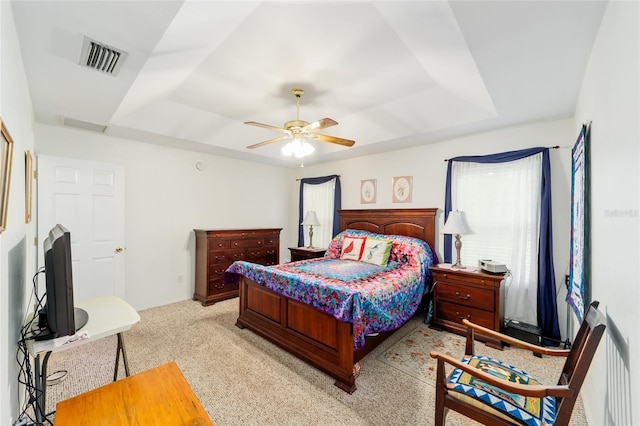 1602 NW 117th Ter, Gainesville, FL 32606 - bedroom featuring a tray ceiling, light colored carpet, and a ceiling fan