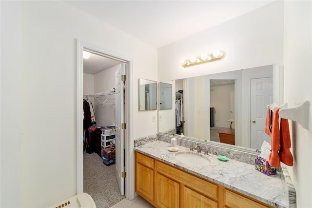 1602 NW 117th Ter, Gainesville, FL 32606 - bathroom featuring vanity, a spacious closet, and tile patterned flooring