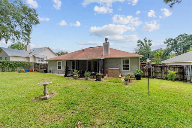 1602 NW 117th Ter, Gainesville, FL 32606 - back of house with a fenced backyard, a chimney, and a shingled roof