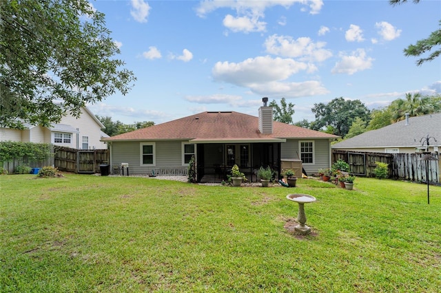 1602 NW 117th Ter, Gainesville, FL 32606 - rear view of house featuring a sunroom, a fenced backyard, and a chimney
