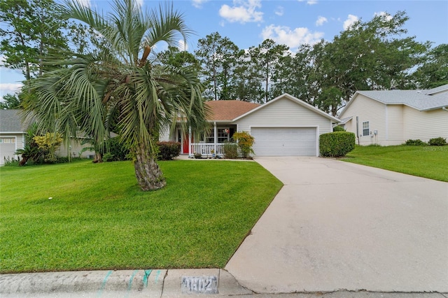 1602 NW 117th Ter, Gainesville, FL 32606 - view of front facade with a porch, driveway, a front lawn, and an attached garage