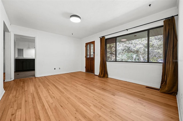 2225 NE 6th Ter, Gainesville, FL 32609 - unfurnished room featuring light wood-style flooring