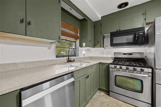 2225 NE 6th Ter, Gainesville, FL 32609 - kitchen featuring green cabinets and appliances with stainless steel finishes