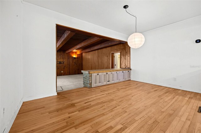 2225 NE 6th Ter, Gainesville, FL 32609 - unfurnished living room with light wood finished floors and wooden walls