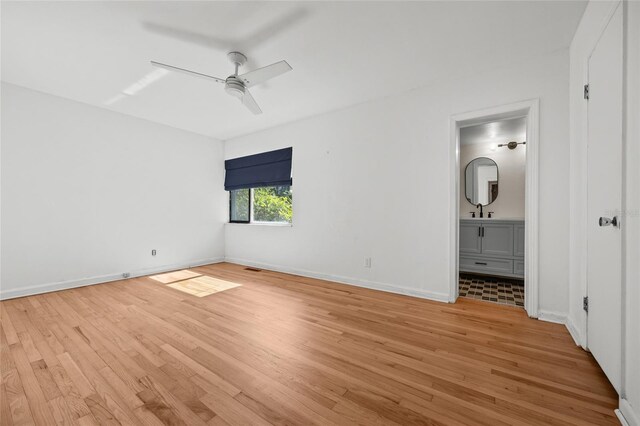 2225 NE 6th Ter, Gainesville, FL 32609 - unfurnished bedroom featuring light wood finished floors, ensuite bath, and ceiling fan