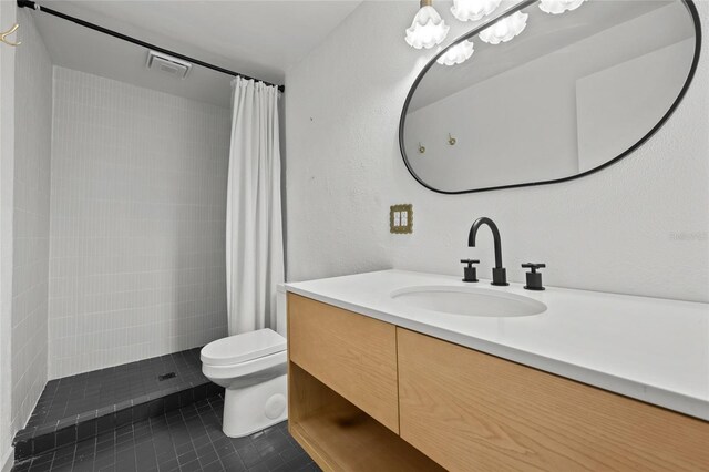 2225 NE 6th Ter, Gainesville, FL 32609 - full bath with tile patterned flooring, vanity, and a tile shower