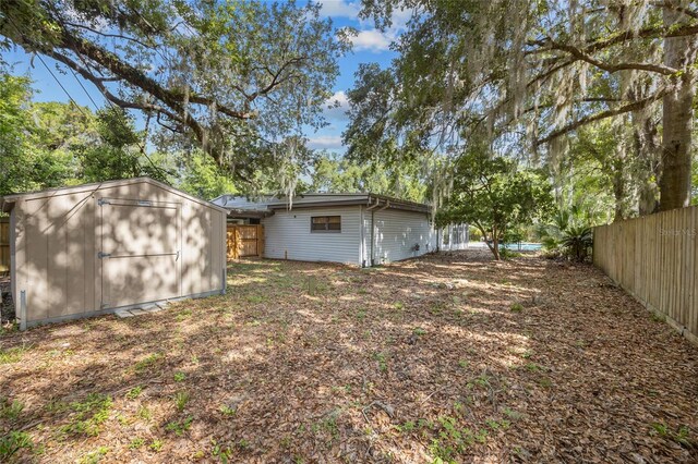 2225 NE 6th Ter, Gainesville, FL 32609 - fenced backyard with a storage unit