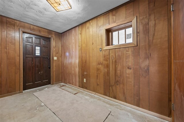 2225 NE 6th Ter, Gainesville, FL 32609 - entrance foyer featuring wooden walls and unfinished concrete flooring