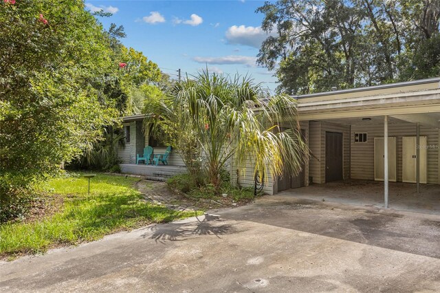 2225 NE 6th Ter, Gainesville, FL 32609 - view of front facade with driveway and an attached carport