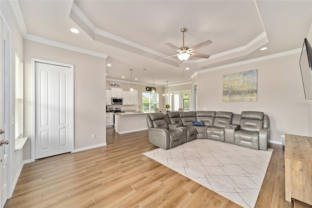 2782 SW 120th Dr, Gainesville, FL 32608 - living room featuring a raised ceiling, a ceiling fan, recessed lighting, light wood-type flooring, and crown molding
