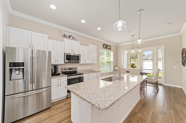 2782 SW 120th Dr, Gainesville, FL 32608 - kitchen with stainless steel appliances, white cabinets, ornamental molding, a kitchen island with sink, and light wood-type flooring