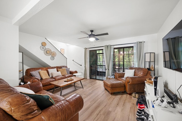 900 SW 62nd Blvd Unit I56, Gainesville, FL 32607 - living room with light wood-type flooring, ceiling fan, and stairway