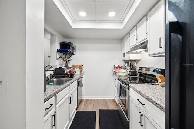 900 SW 62nd Blvd Unit I56, Gainesville, FL 32607 - kitchen featuring appliances with stainless steel finishes, under cabinet range hood, light wood-type flooring, white cabinets, and recessed lighting