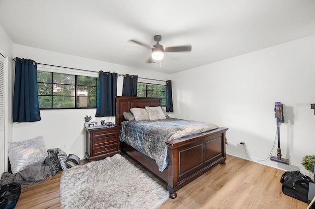 900 SW 62nd Blvd Unit I56, Gainesville, FL 32607 - bedroom with light wood-type flooring, multiple windows, and ceiling fan