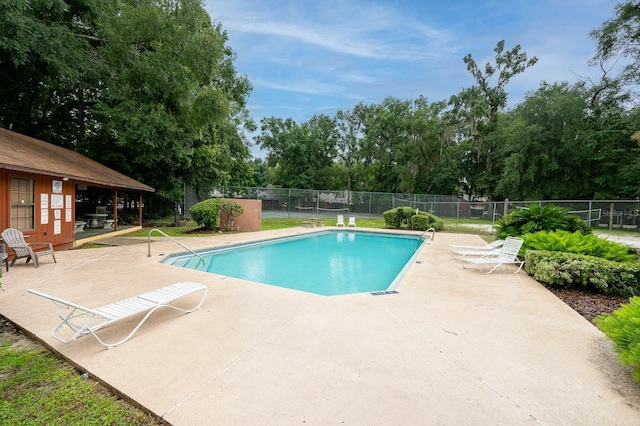 900 SW 62nd Blvd Unit I56, Gainesville, FL 32607 - community pool featuring a patio area and view of wooded area
