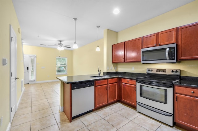 2960 SW 35th Pl Unit 66, Gainesville, FL 32608 - kitchen featuring appliances with stainless steel finishes, dark brown cabinets, light tile patterned floors, a peninsula, and ceiling fan