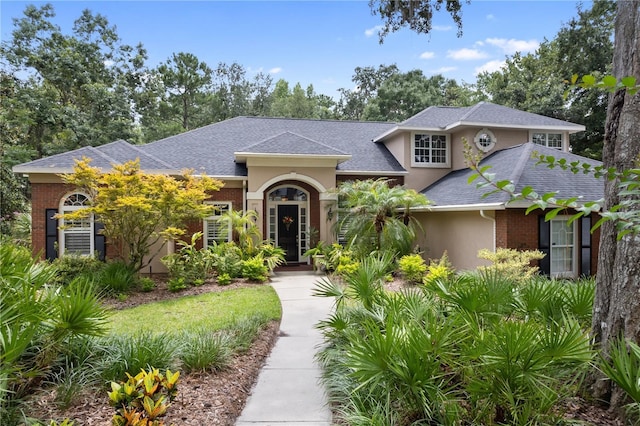 5025 NW 51st Pl, Gainesville, FL 32606 - view of front of property with stucco siding and a shingled roof