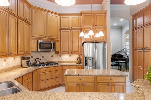 5025 NW 51st Pl, Gainesville, FL 32606 - kitchen featuring stainless steel appliances, arched walkways, ornamental molding, light stone countertops, and decorative backsplash