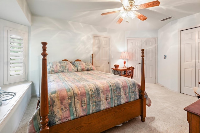5025 NW 51st Pl, Gainesville, FL 32606 - bedroom with light carpet, ceiling fan, and two closets