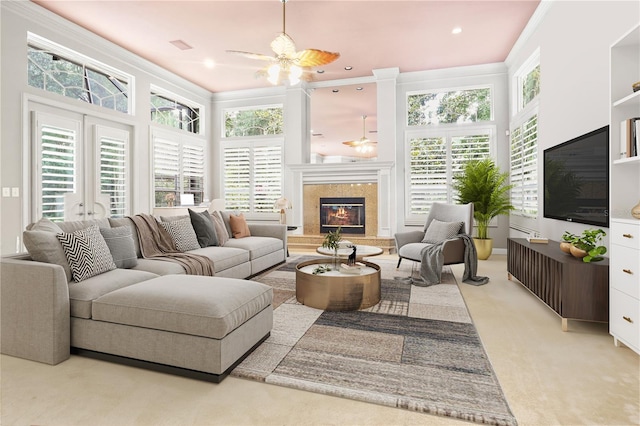 5025 NW 51st Pl, Gainesville, FL 32606 - living area with a ceiling fan, crown molding, plenty of natural light, a premium fireplace, and light carpet