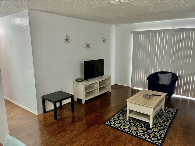 3705 SW 27th St Unit 1112, Gainesville, FL 32608 - living room featuring wood finished floors and a textured ceiling
