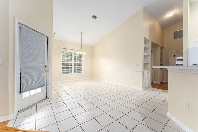 8036 SW 72nd Pl, Gainesville, FL 32608 - spare room with a chandelier, high vaulted ceiling, and light tile patterned flooring