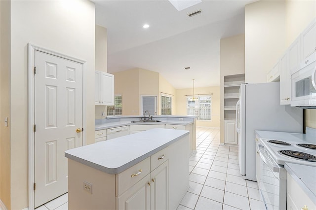 8036 SW 72nd Pl, Gainesville, FL 32608 - kitchen featuring a peninsula, white appliances, lofted ceiling, light tile patterned floors, and a kitchen island