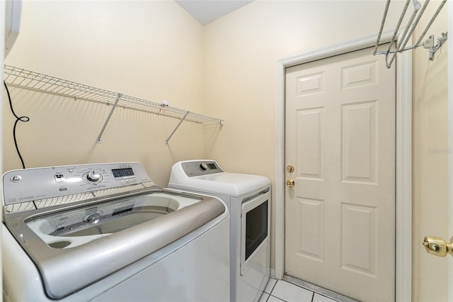 8036 SW 72nd Pl, Gainesville, FL 32608 - washroom with washer and clothes dryer and light tile patterned floors