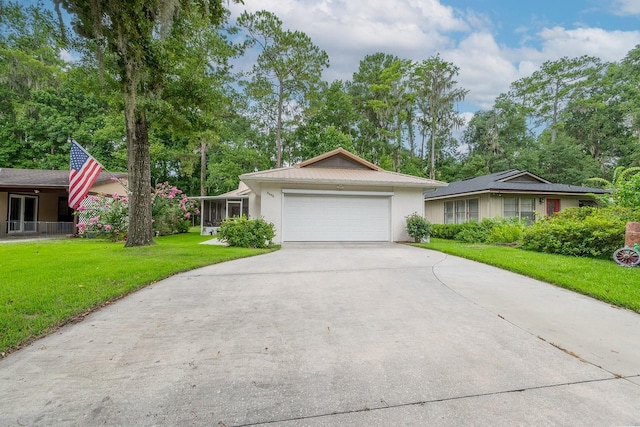 8488 NW 39th Ter, Gainesville, FL 32653 - ranch-style home with concrete driveway, a front yard, stucco siding, and an attached garage