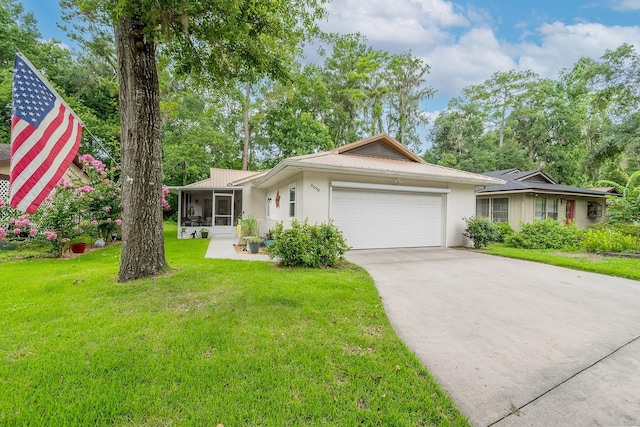 8488 NW 39th Ter, Gainesville, FL 32653 - ranch-style home with an attached garage, concrete driveway, stucco siding, a sunroom, and a front lawn