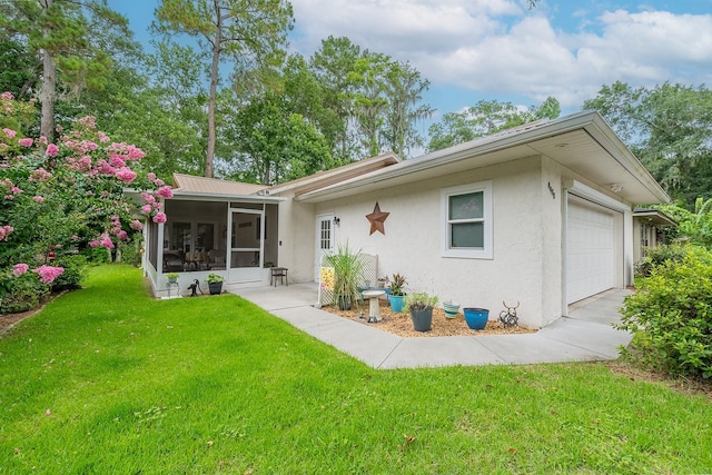 8488 NW 39th Ter, Gainesville, FL 32653 - view of front of home with a sunroom, stucco siding, a front yard, and a garage