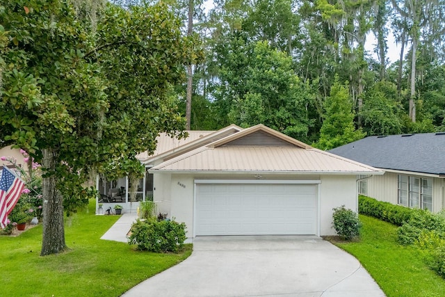 8488 NW 39th Ter, Gainesville, FL 32653 - view of front of home featuring driveway, a garage, a front yard, a metal roof, and stucco siding