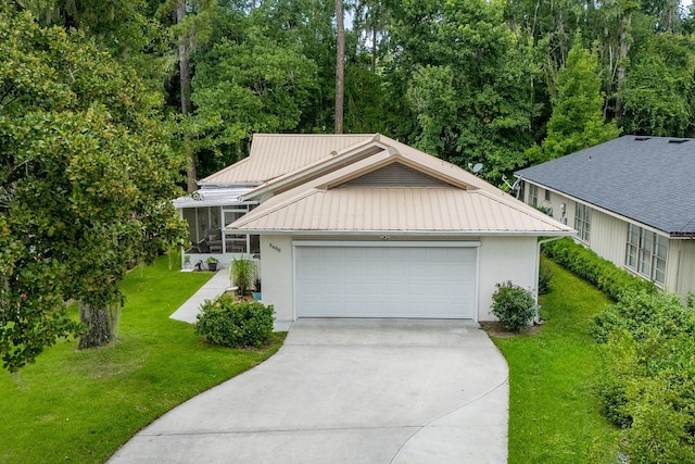 8488 NW 39th Ter, Gainesville, FL 32653 - view of front facade with a sunroom, concrete driveway, a metal roof, stucco siding, and a front lawn