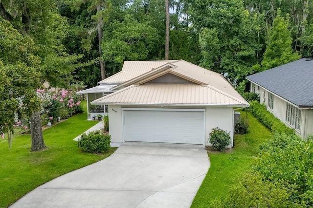 8488 NW 39th Ter, Gainesville, FL 32653 - view of front of house with driveway, a metal roof, a front lawn, stucco siding, and a garage
