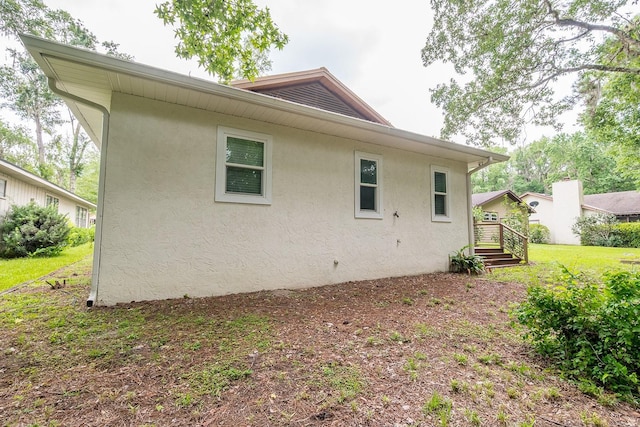 8488 NW 39th Ter, Gainesville, FL 32653 - back of house featuring stucco siding and a yard