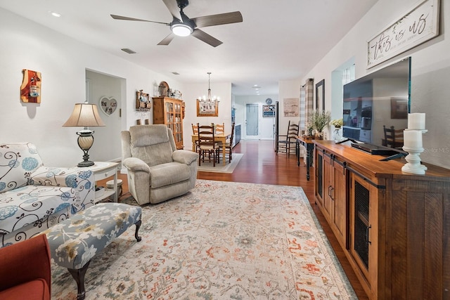 8488 NW 39th Ter, Gainesville, FL 32653 - living room with wood finished floors, a chandelier, and a ceiling fan