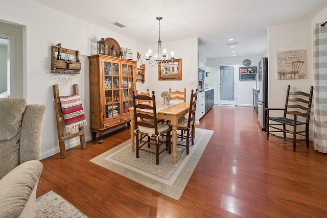 8488 NW 39th Ter, Gainesville, FL 32653 - dining area featuring a chandelier, dark wood-style floors, and recessed lighting