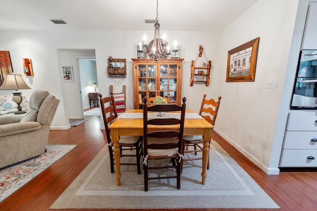 8488 NW 39th Ter, Gainesville, FL 32653 - dining room with a chandelier and wood finished floors