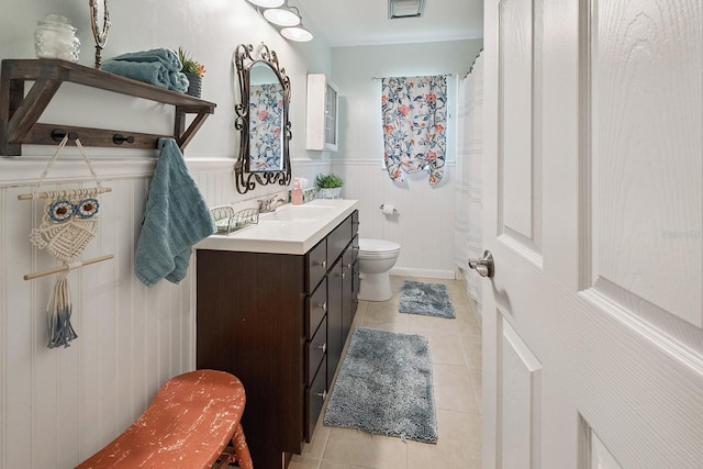 8488 NW 39th Ter, Gainesville, FL 32653 - full bath featuring vanity, tile patterned floors, and wainscoting