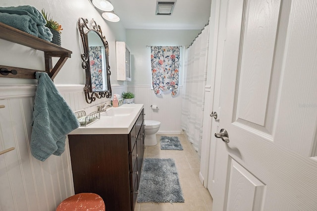 8488 NW 39th Ter, Gainesville, FL 32653 - bathroom featuring vanity, tile patterned flooring, a wainscoted wall, and a shower with shower curtain