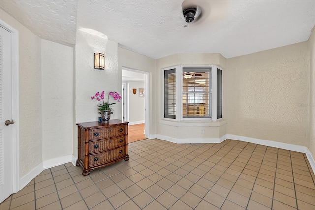 4555 S Atlantic Ave Unit 4603, Ponce Inlet, FL 32127 - unfurnished room with a textured wall, light tile patterned floors, and a textured ceiling