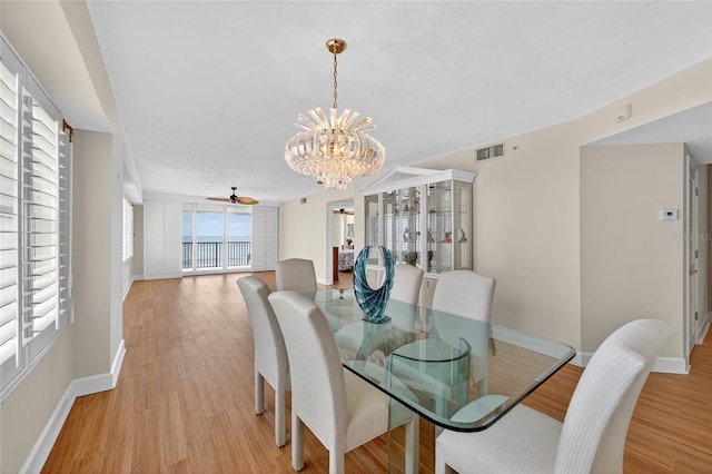 4555 S Atlantic Ave Unit 4603, Ponce Inlet, FL 32127 - dining area featuring a chandelier, light wood-style flooring, and a ceiling fan