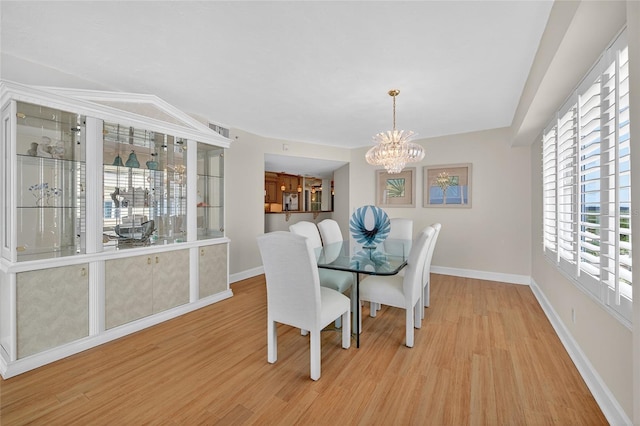 4555 S Atlantic Ave Unit 4603, Ponce Inlet, FL 32127 - dining space with a chandelier and light wood-style flooring