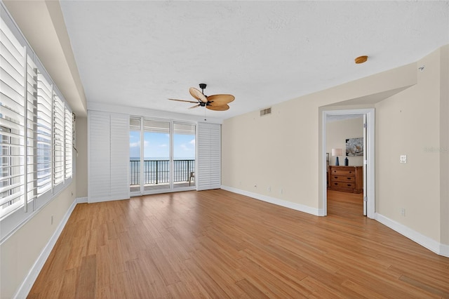 4555 S Atlantic Ave Unit 4603, Ponce Inlet, FL 32127 - spare room with a ceiling fan, light wood-style floors, a water view, and a smoke detector