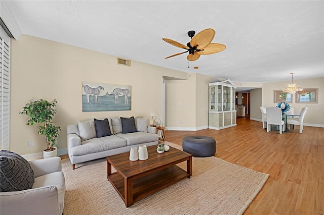4555 S Atlantic Ave Unit 4603, Ponce Inlet, FL 32127 - living room featuring a ceiling fan, a chandelier, and light wood-type flooring