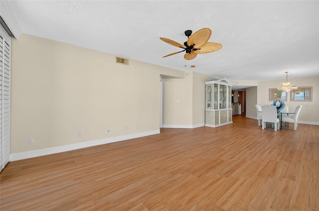 4555 S Atlantic Ave Unit 4603, Ponce Inlet, FL 32127 - unfurnished living room with a chandelier, a ceiling fan, and light wood-style floors