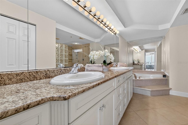 4555 S Atlantic Ave Unit 4603, Ponce Inlet, FL 32127 - bathroom featuring double vanity, a garden tub, a stall shower, tile patterned flooring, and a raised ceiling